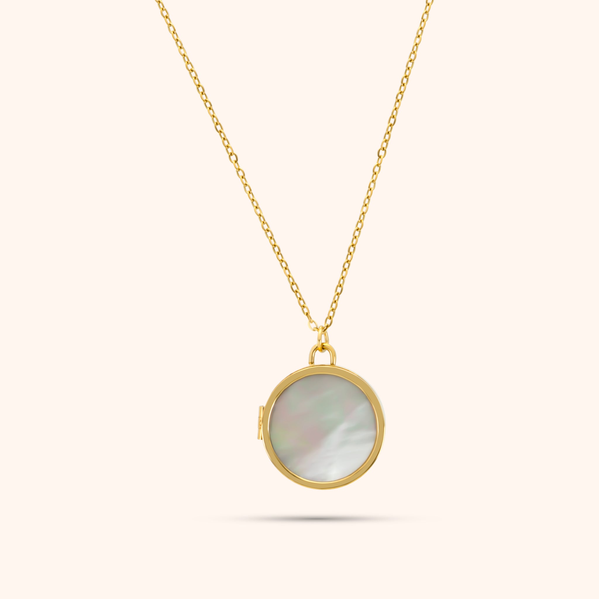 PRESSIE Treasured Locket necklace; an 18k gold plated delicate chain with a round mother-of-pearl inlaid locket.